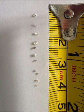 Eleven tiny round brilliant cut faceted diamonds - mixed sizes
